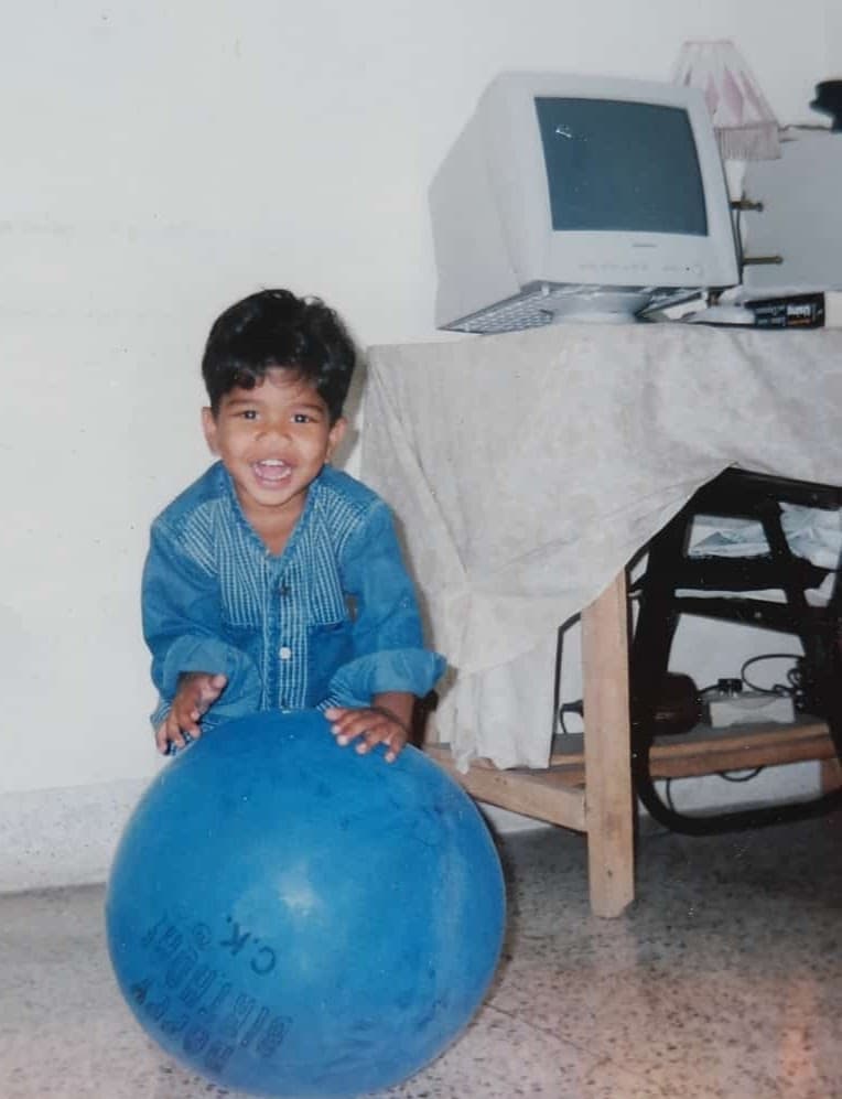 Young Pranay at home with the CRT monitor in the background